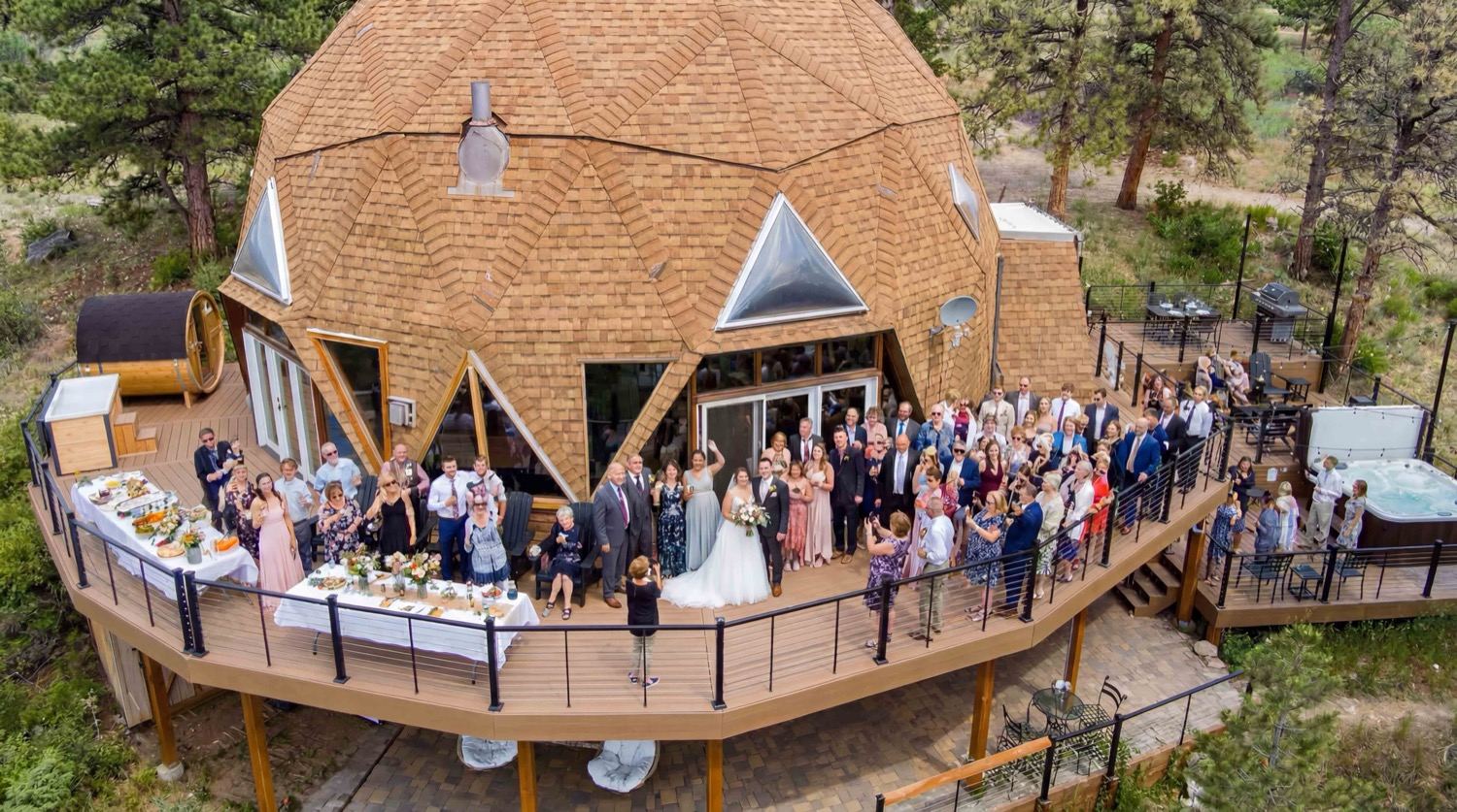 The full wedding party gathered on the deck wrapped around the dome